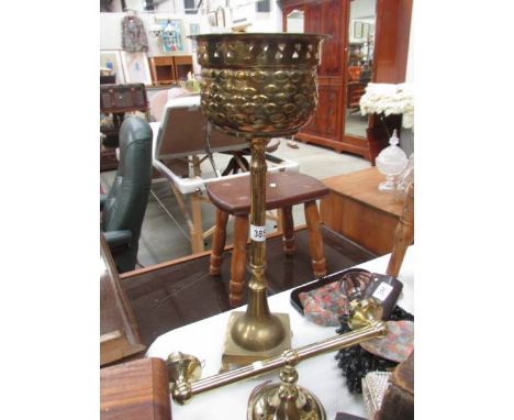 A brass planter and a brass wall light.
