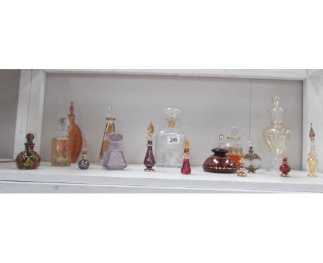 A shelf of assorted perfume bottles.