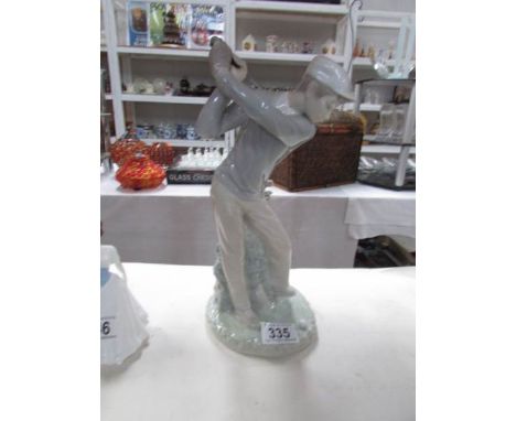 A NAO boy golfing figurine.