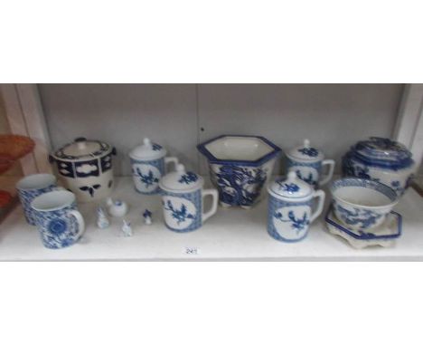 A shelf of assorted blue and white china including oriental.