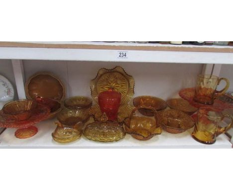 A shelf of amber and carnival glass.