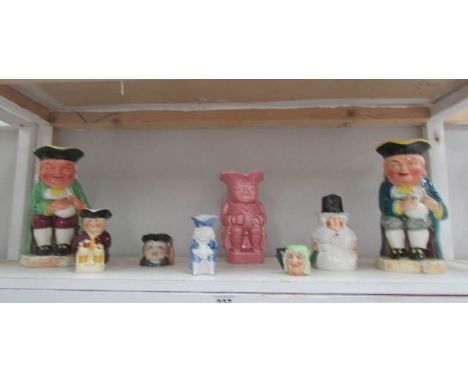 A shelf of assorted Toby jugs.