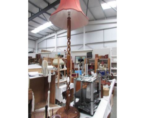 A wooden standard lamp with shade.