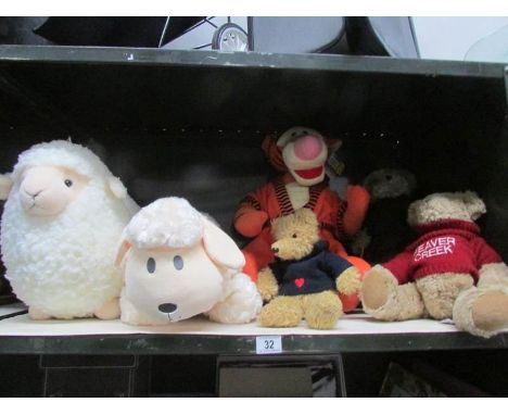 A shelf of soft toys including teddy bears, Disney's Tigger, 2 sheep etc (one is Mama's and Papa's).