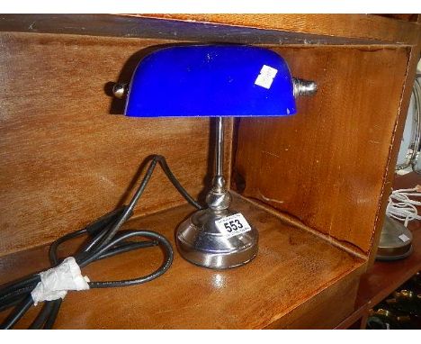 A small bankers lamp with blue glass shade.