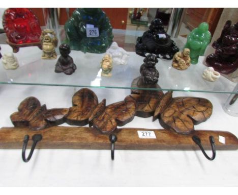 A wooden butterfly coat hook.