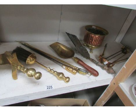 A shelf of brass fire implements etc.,