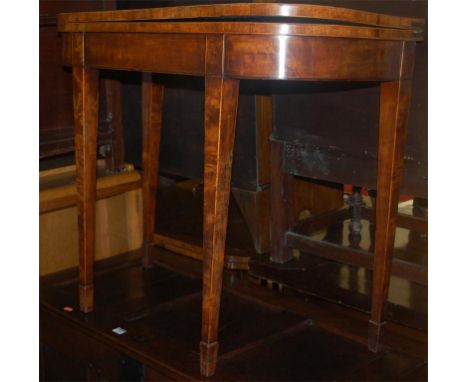 An early 19th century mahogany and satinwood strung round cornered fold-over card table 