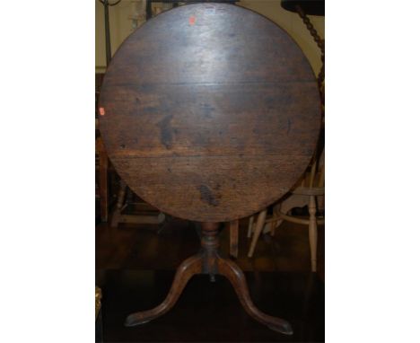 A George III oak circular tilt-top tripod table 