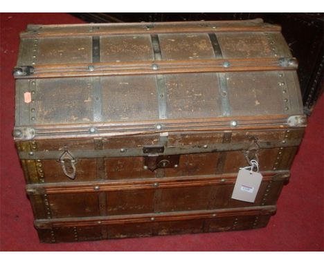 An early 20th century canvas, wooden and metal bound hinge dome top travelling trunk with fitted interior, width 68cm