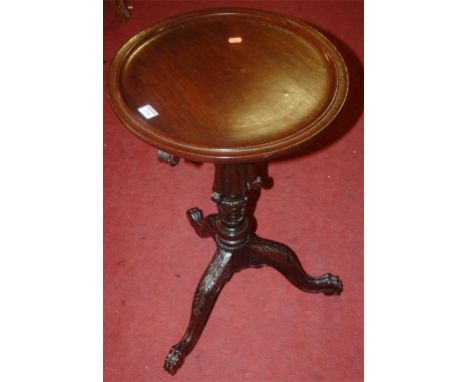 A circa 1900 low relief carved padouk?, a circular fixed top pedestal tripod table, raised on acanthus leaf hipped supports