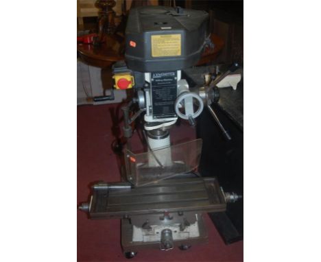 A large Axminster pillar drill, raised on painted metal base, with a large selection of spare parts and fittings