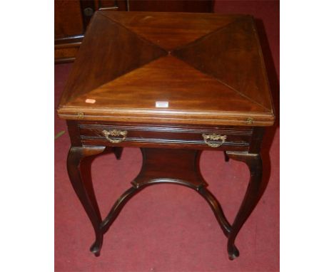 An Edwardian walnut envelope card table, having revolving action and single long drawer, w.56cm