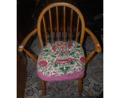 A pair of Ercol light elm stickback elbow chairs; together with a stickback side chair (3)