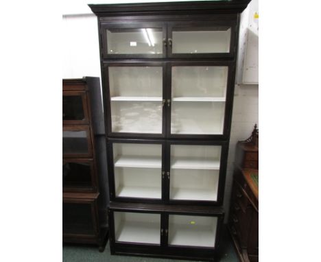 Esavian dark stained bookcase of four sections, each section with two glazed doors, the two middle sections each with single 