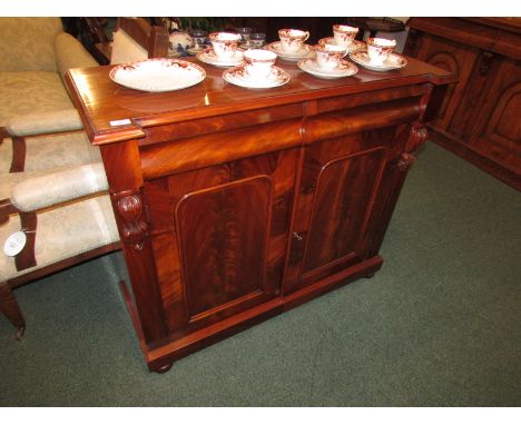 A Victorian mahogany chiffonier, the frieze with two cushion drawers, the cupboard doors with plain moulded panels and a sing