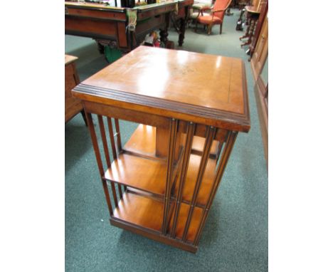 Revolving library bookcase probably dating from first or second quarter of 20th century with maple veneered top and harewood 