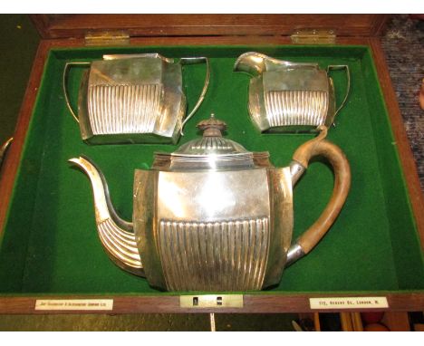 Silver three-part tea set in a fitted oak case, comprising teapot of half-reeded oblong form with fruitwood handle and knop (