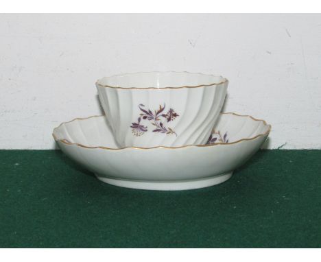 Worcester Flight and Barr period wrythen tea bowl and saucer, white porcelain with mauve sprays and gilding, the bases marked