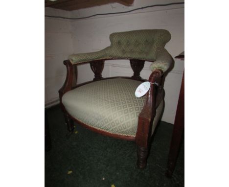 An Edwardian red walnut upholstered button back salon chair in green lattice upholstery. The open back stretchers and arms ar