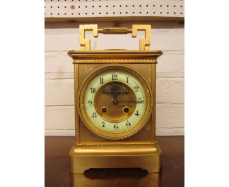 Gilt chiming mantel clock with visible escapement and slow/fast adjustment, cream enamel Arabic chapter with black numerals, 