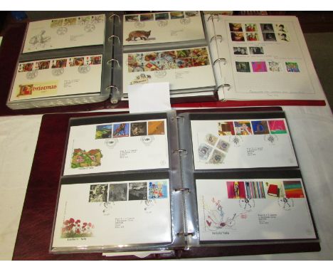 Two maroon ring binders of Royal Mail First Day Covers and red ring binder of Royal Mail special edition franked and unfranke