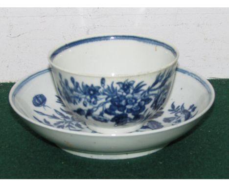 Worcester First Period blue and white tea bowl and saucer, patterned with flowers and butterflies, crescent mark to base of c