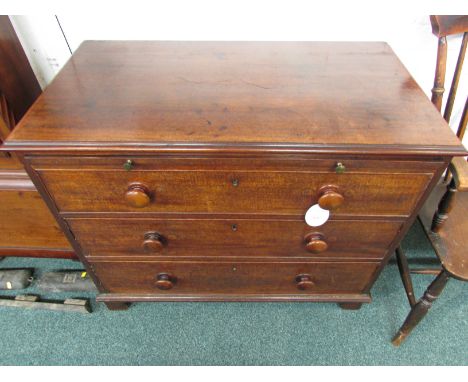 Victorian mahogany chest of three drawers with a brush slide topped with green baize, the drawer handles being turned wooden 