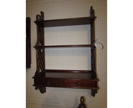 Mahogany wall bracket of three shelves of graduated depth, bottom shelf having two drawers under with blind fret fronts, the 