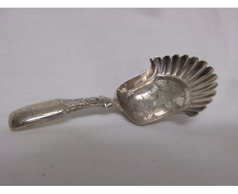 George IV silver caddy spoon, the shovel-shaped bowl with scallop rim and foliate chasing, the chased stem engraved with init