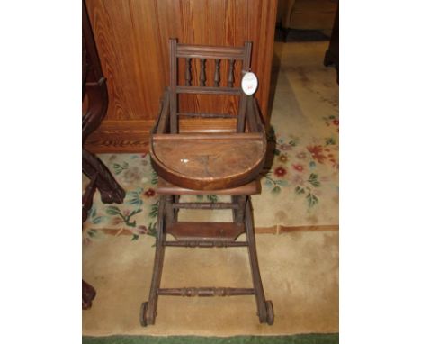 Edwardian mahogany child's metamorphic high chair with clutch operated mechanism folding down to a pushchair, with commode se