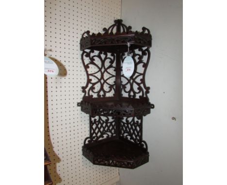 Mahogany three shelf corner wall bracket, with open fret back and pierced galleries (76cm x 33cm)