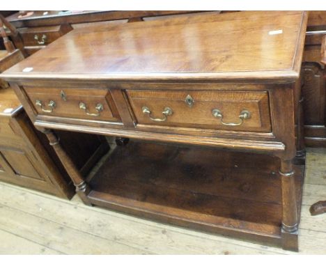 A modern medium light oak two door hall table on turned legs and three plank bottom shelf