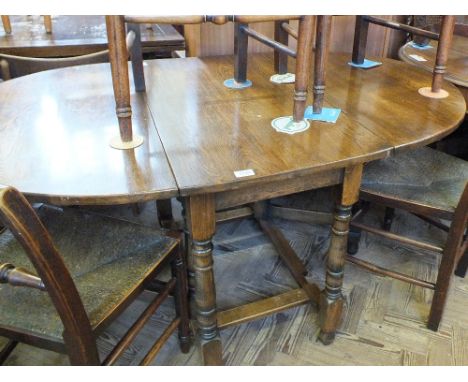 An oval oak gate leg dining table