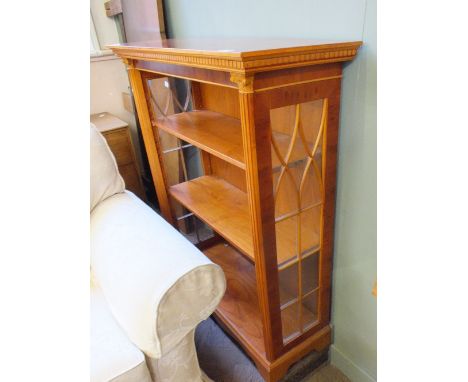 A modern yew three shelf bookcase with carved Corrinthean column detail