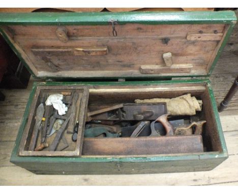 A green painted pine carpenters tool chest with a selection of tools including planes, saws etc