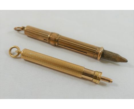 A 9 carat gold pencil holder with propelling action, marks rubbed, 6.8cm long, and an unmarked propelling pencil with engine 