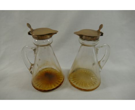 A pair of George V silver mounted glass whisky noggins, Birmingham 1932 by Mappin and Webb, with cut glass bases, 11cm high C