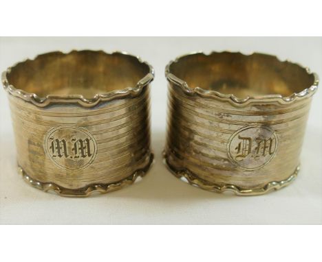 A pair of silver napkin rings, Birmingham 1927, with engine turned decoration and shaped rims, combined weight 1.59ozt, 49.5o