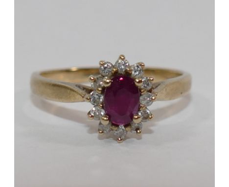 A 9 carat gold ruby and diamond oval cluster ring, with import marks for London 1977, finger size O 1/2, 2.5g gross, boxed CO