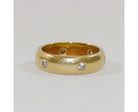 An 18 carat gold diamond set band, the D-shaped band set with six small round brilliant cut diamonds, each approximately 0.04
