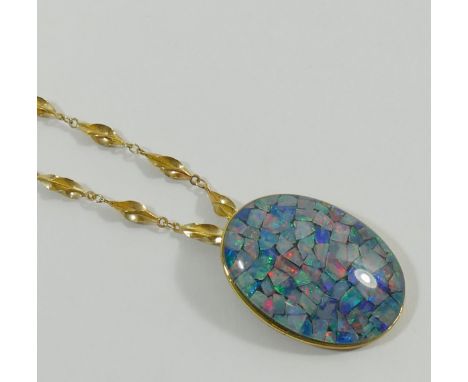 An oval opal chip triplet pendant in yellow metal mount stamped '9K', 3cm long, and a 9 carat gold twisted link chain 48.5cm 