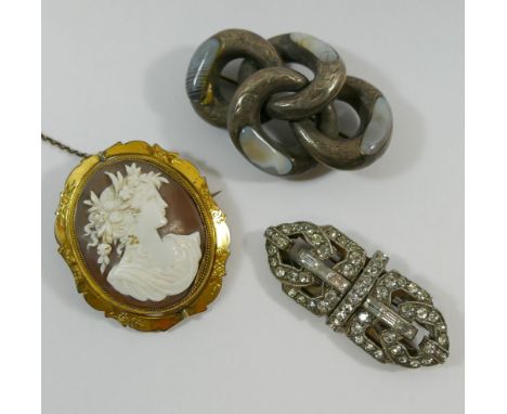 A Victorian carved shell cameo in pinchbeck brooch mount, carved with the head of the Roman goddess Flora, with glazed keepsa