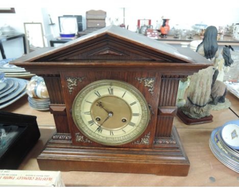 An early 20th century oak cased mantel clock