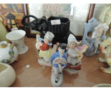 Three figurines and a ceramic elephant
