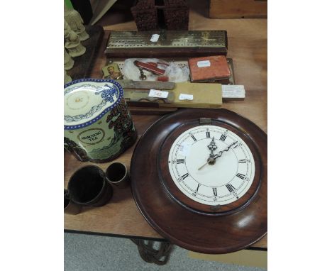 A miscellaneous selection including wall clock, brass finished cribbage boards, enamelled cigarette box, vintage tin containi
