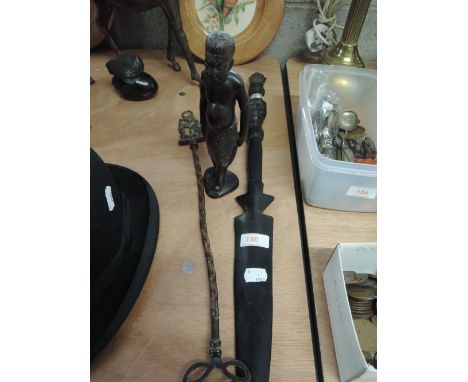 An ethnic carved figurine and carved hand spear and brass toasting fork