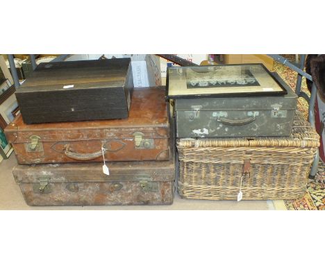 A wicker hamper, two leather suitcases and other items.