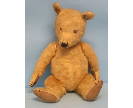 A Chiltern Hugmee teddy bear c1930-40's, the vertically stitched nose with outer stitches extended, honey plush, small pointe