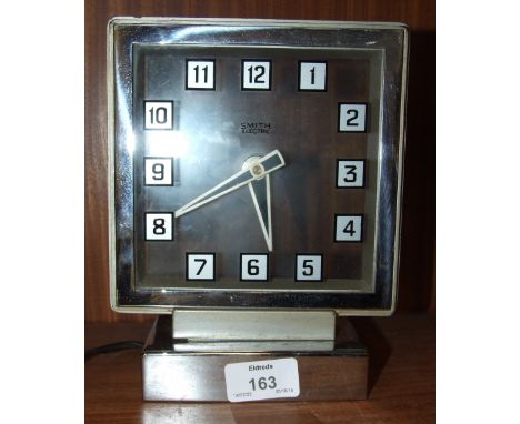 A Smiths electric clock with chromium-plated frame and square dial, 20cm high, 16cm wide and an Elliott walnut shaped mantel 